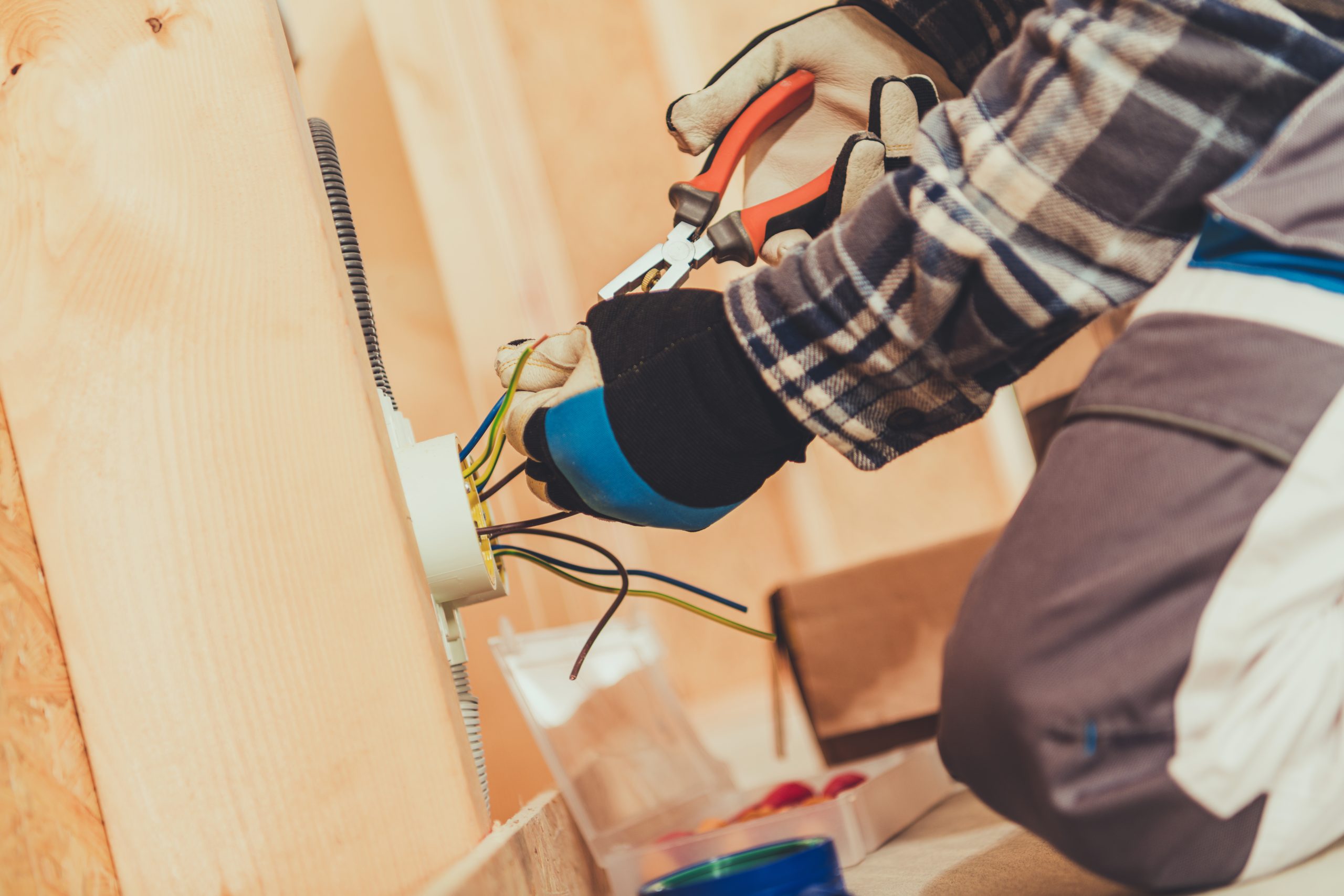 Close Up Of Male Elelctrician Preparing Wire Ends For Plug Installement.